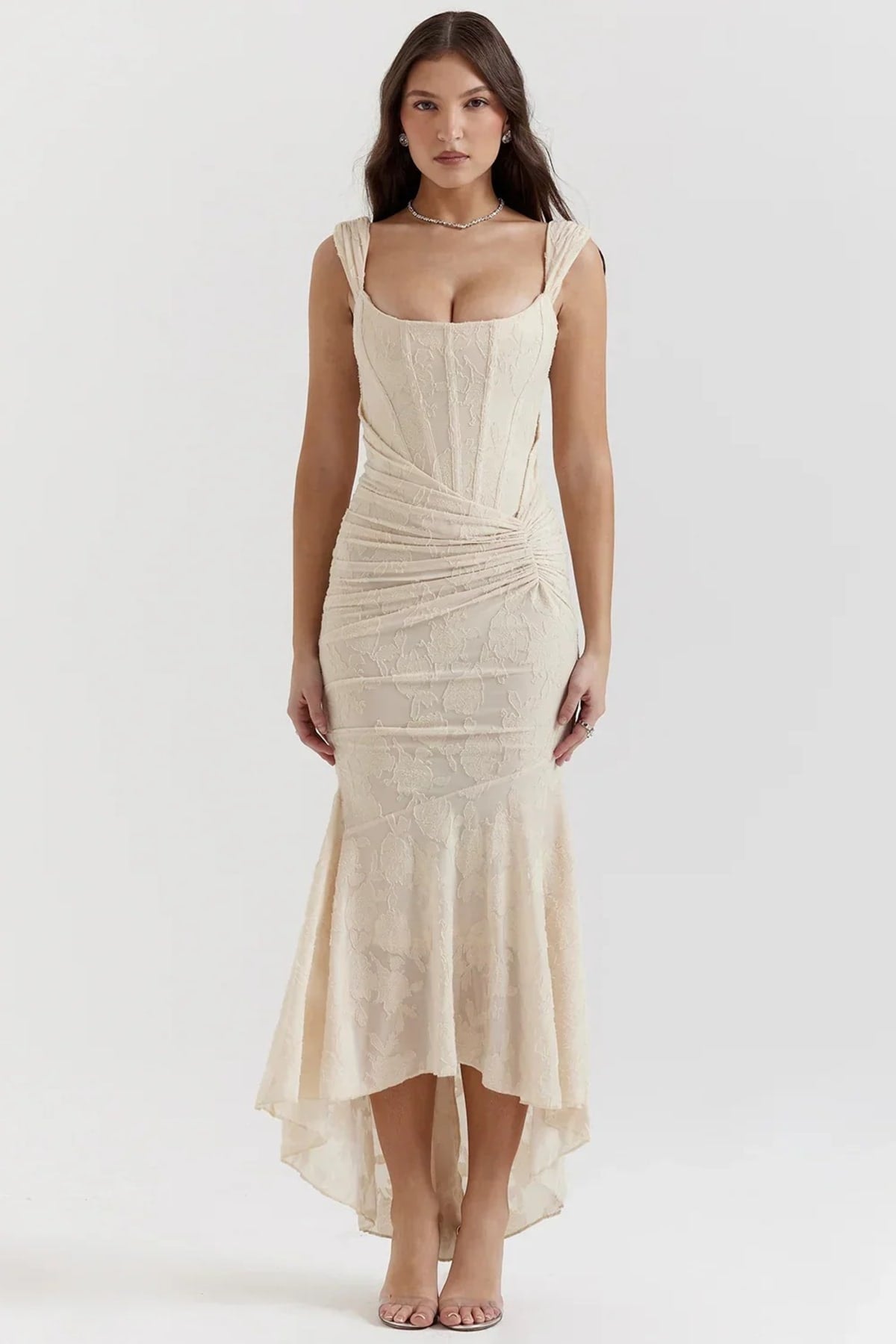 Woman in light blue dress with corset bodice, high-low hem.