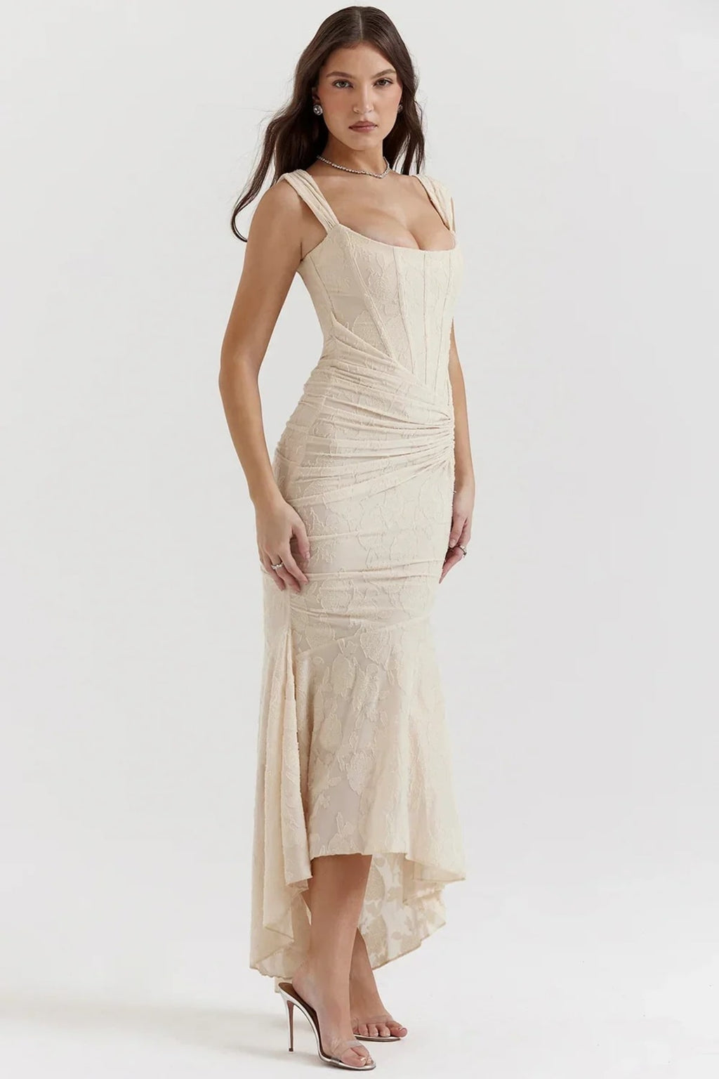 Woman in light blue dress with corset bodice, high-low hem.