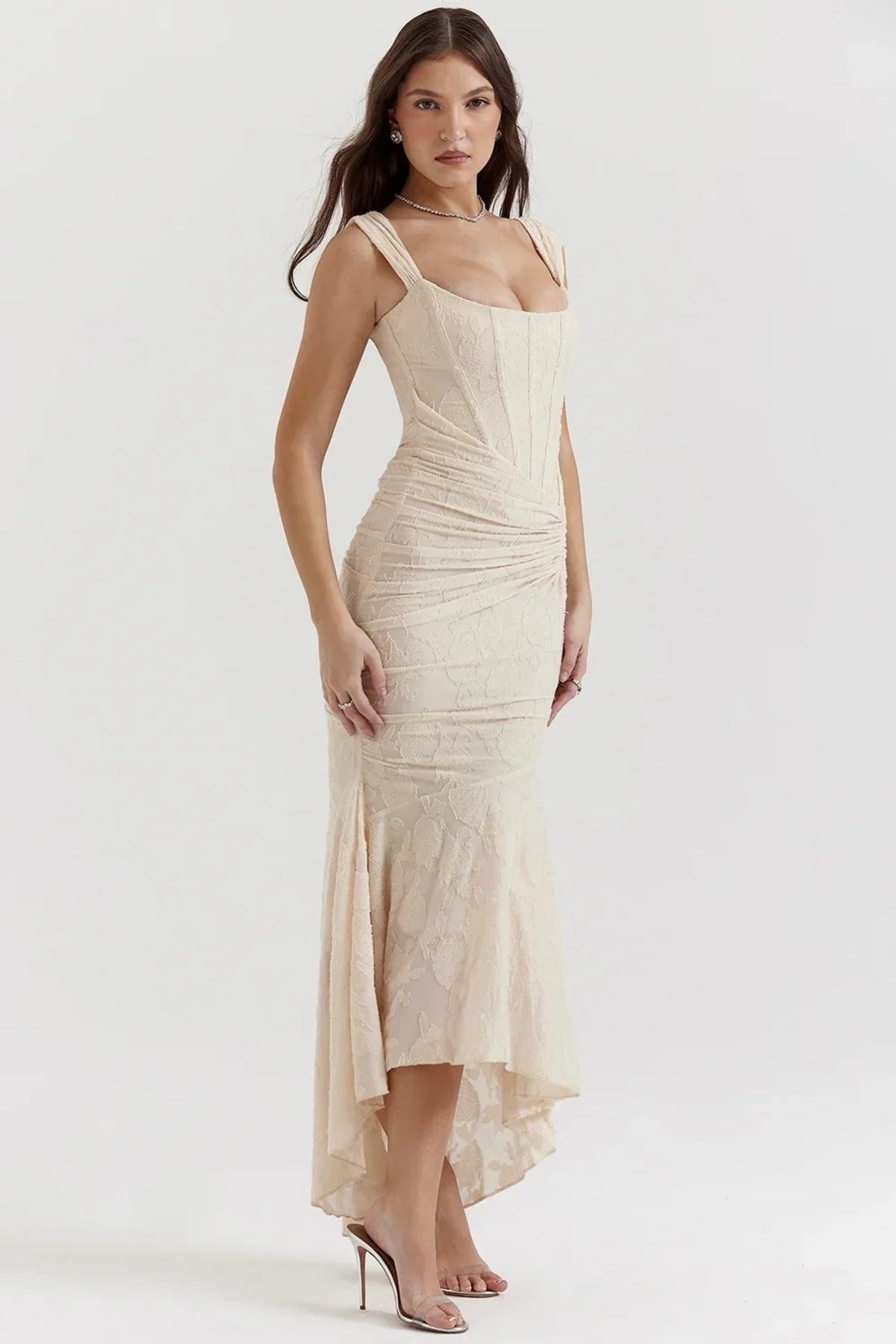 Woman in light blue dress with corset bodice, high-low hem.