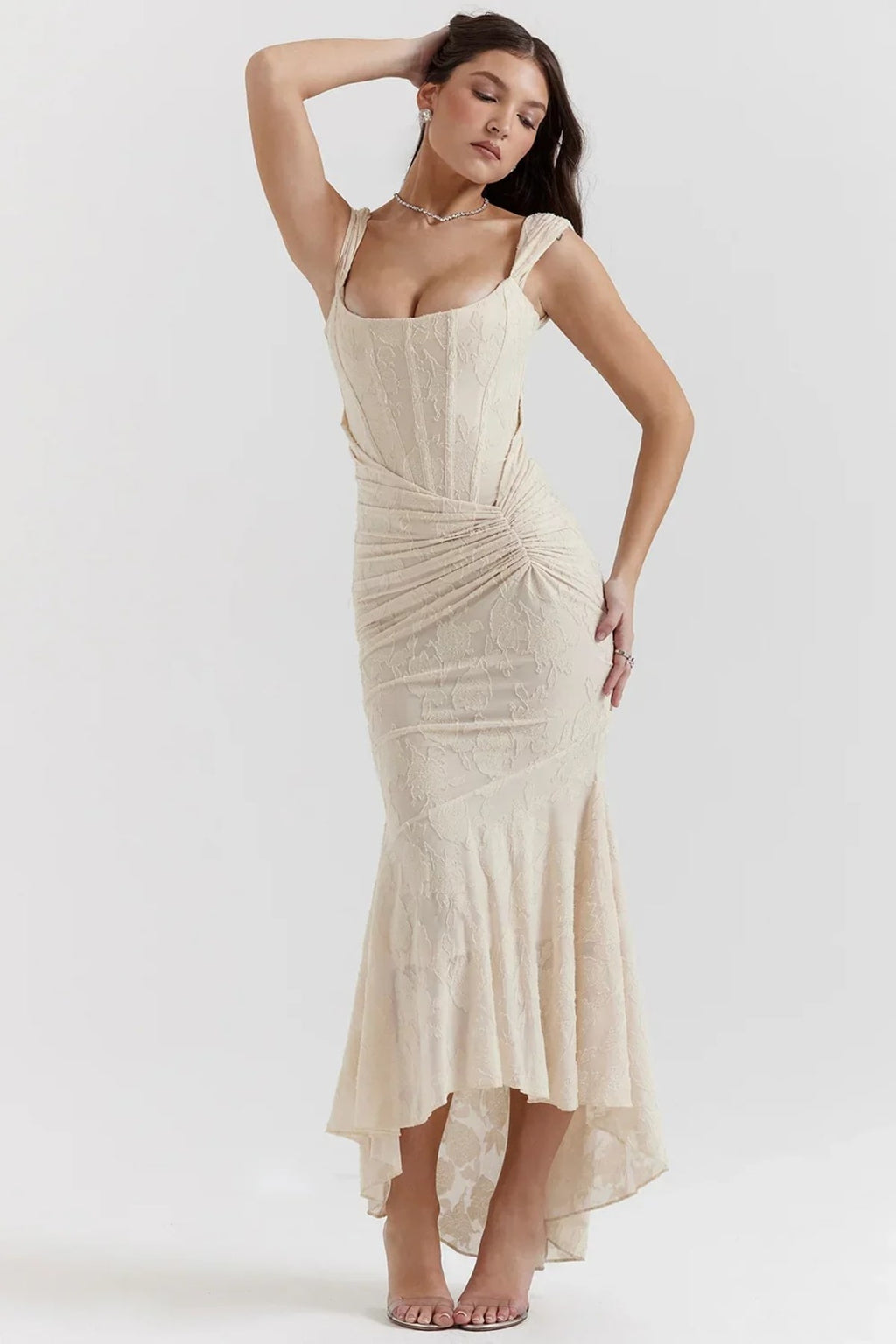 Woman in light blue dress with corset bodice, high-low hem.