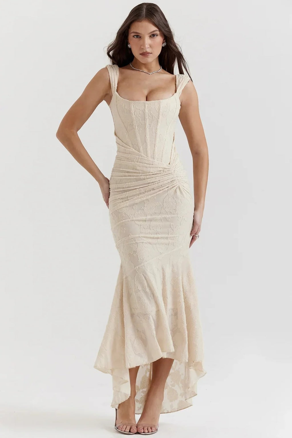 Woman in light blue dress with corset bodice, high-low hem.