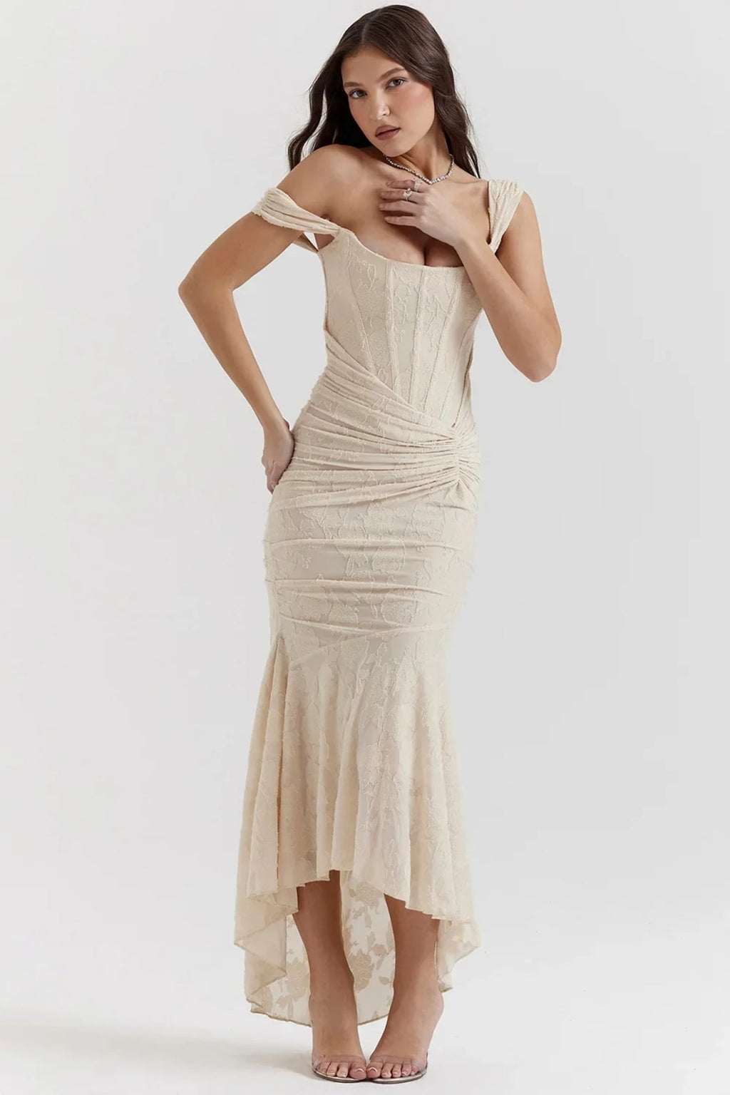 Woman in light blue dress with corset bodice, high-low hem.