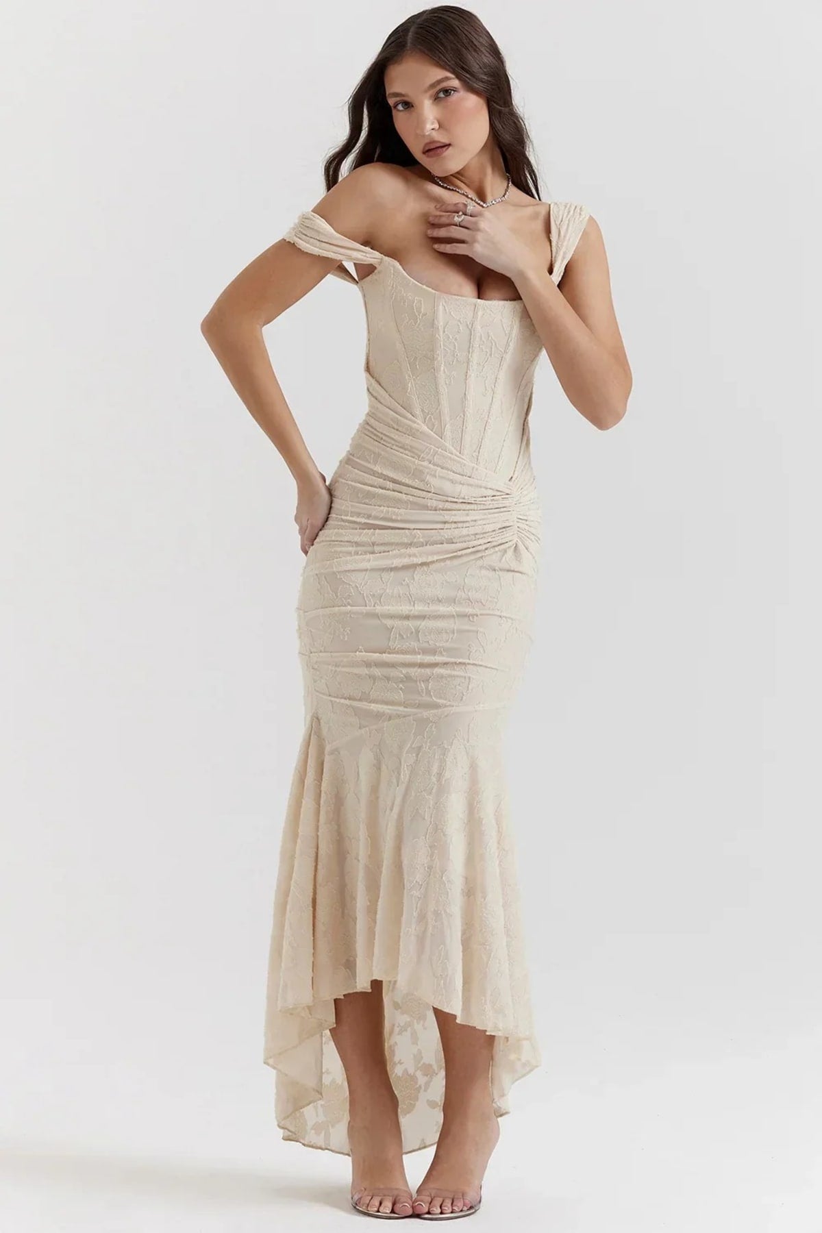 Woman in light blue dress with corset bodice, high-low hem.