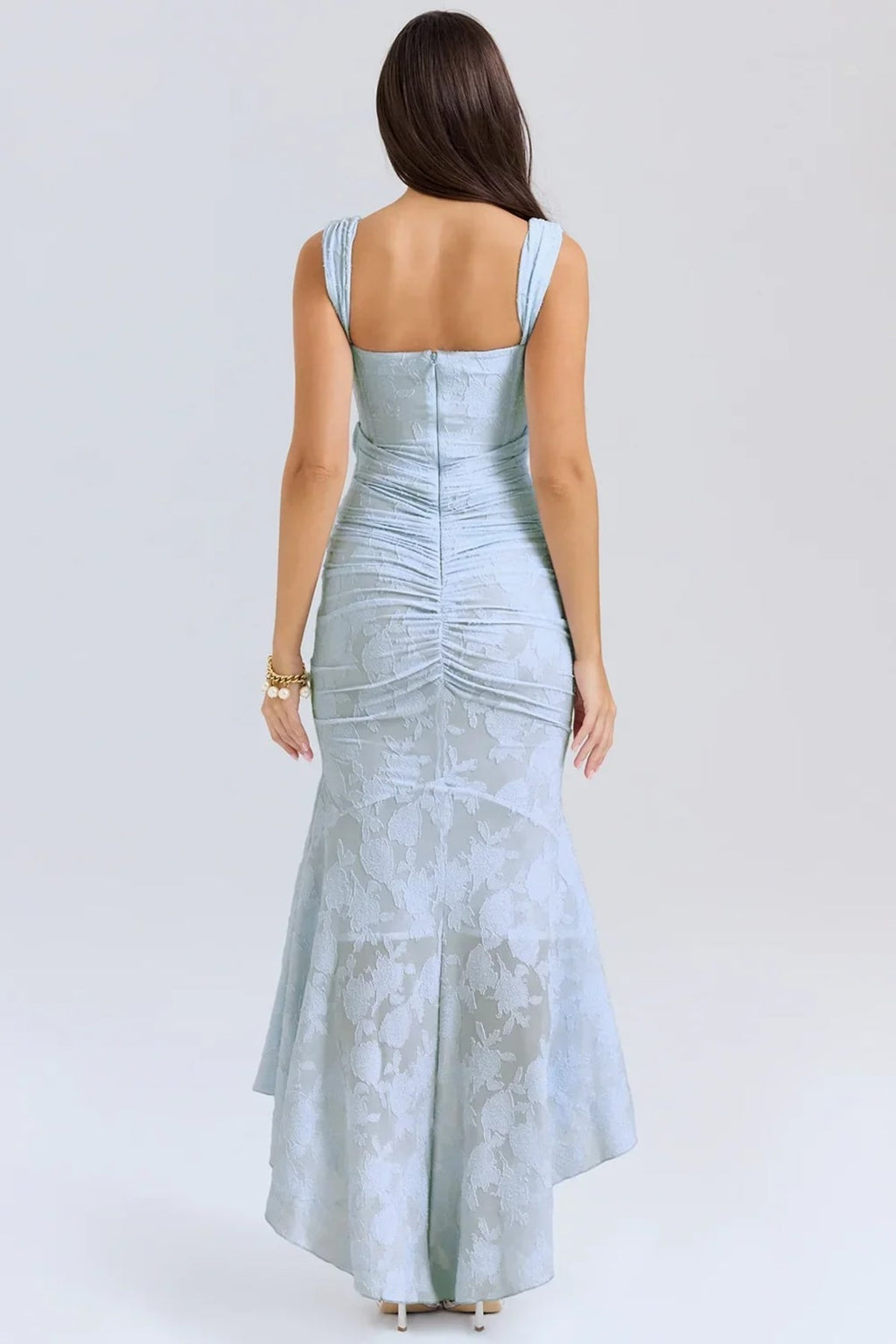 Woman in light blue dress with corset bodice, high-low hem.