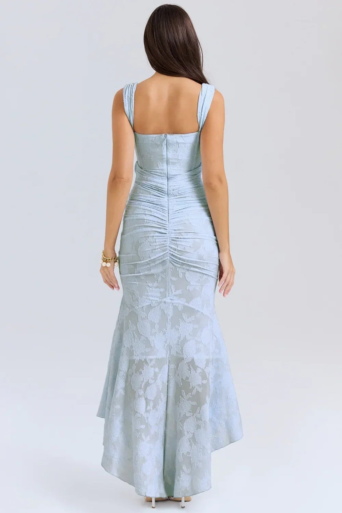 Woman in light blue dress with corset bodice, high-low hem.