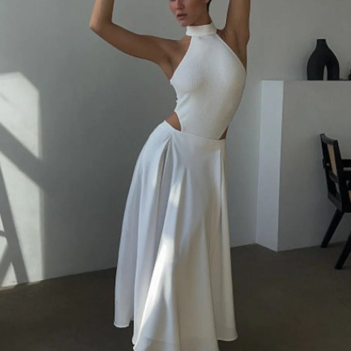 Person wearing a high-waisted maxi skirt with a blazer.