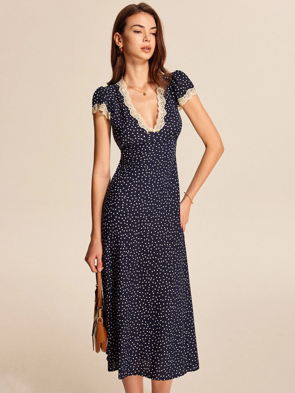 Lace trim polka dot midi dress with cap sleeves and V-neckline.