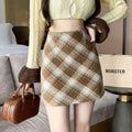 Person wearing a plaid mini skirt with A-line cut.