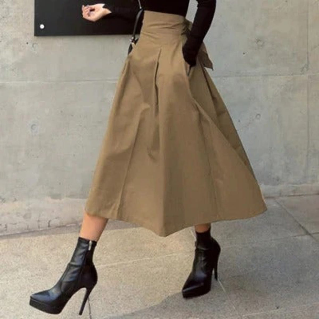 Person wearing high-waisted pleated A-line midi skirt with tie.