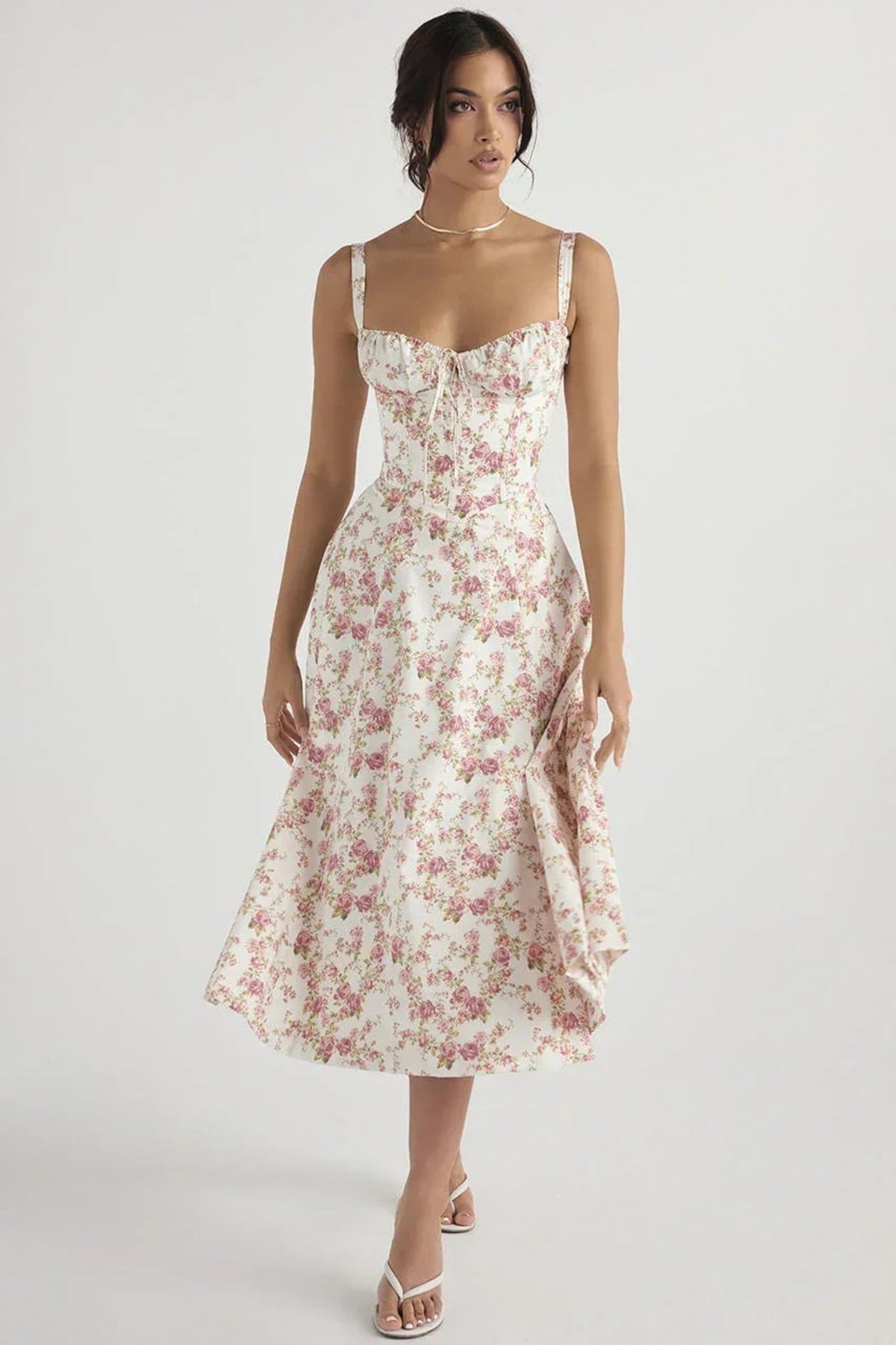 Woman in yellow midi sundress with ruched bust, corset bodice.