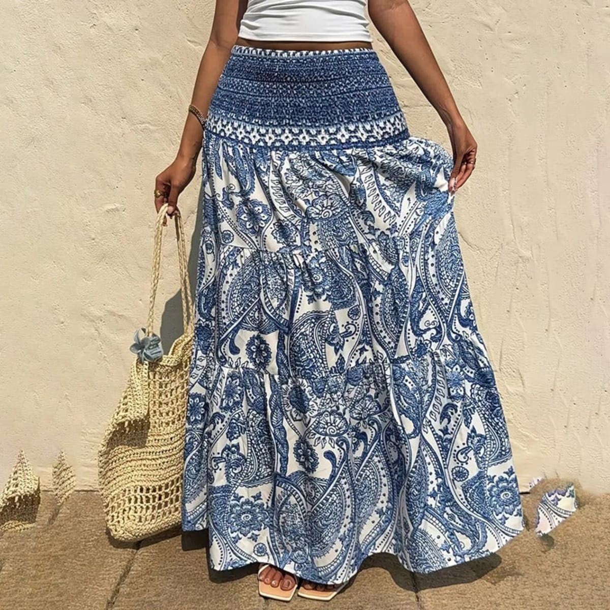 White tiered maxi skirt with blue paisley print and shirred waist.