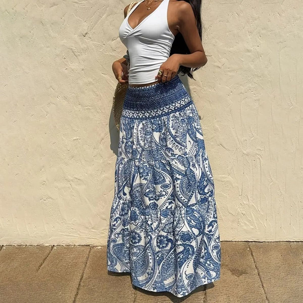 White tiered maxi skirt with blue paisley print and shirred waist.