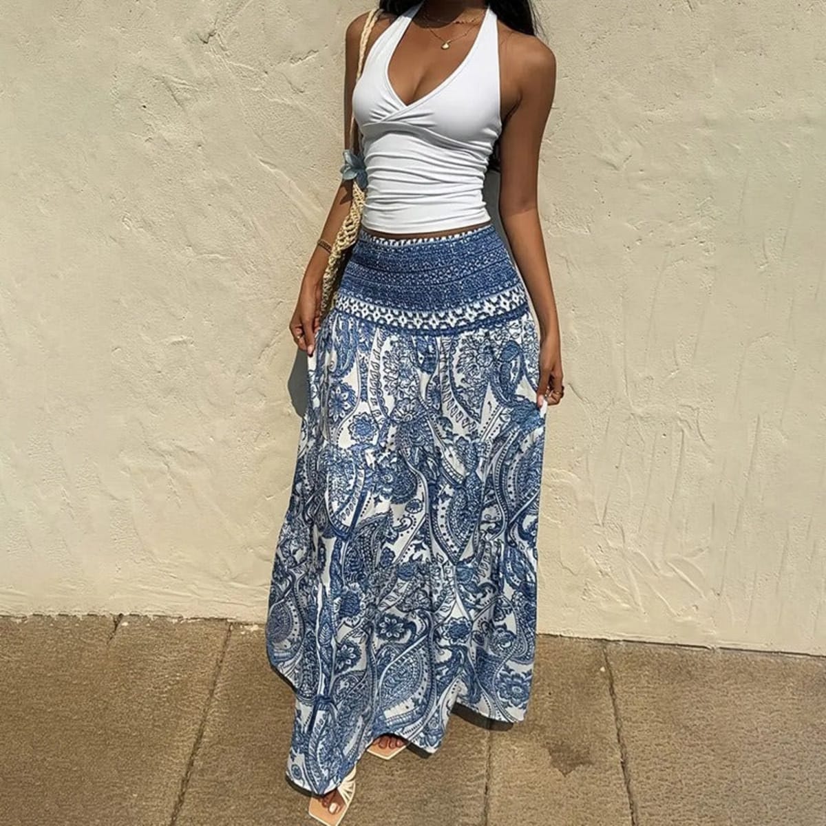 White tiered maxi skirt with blue paisley print and shirred waist.