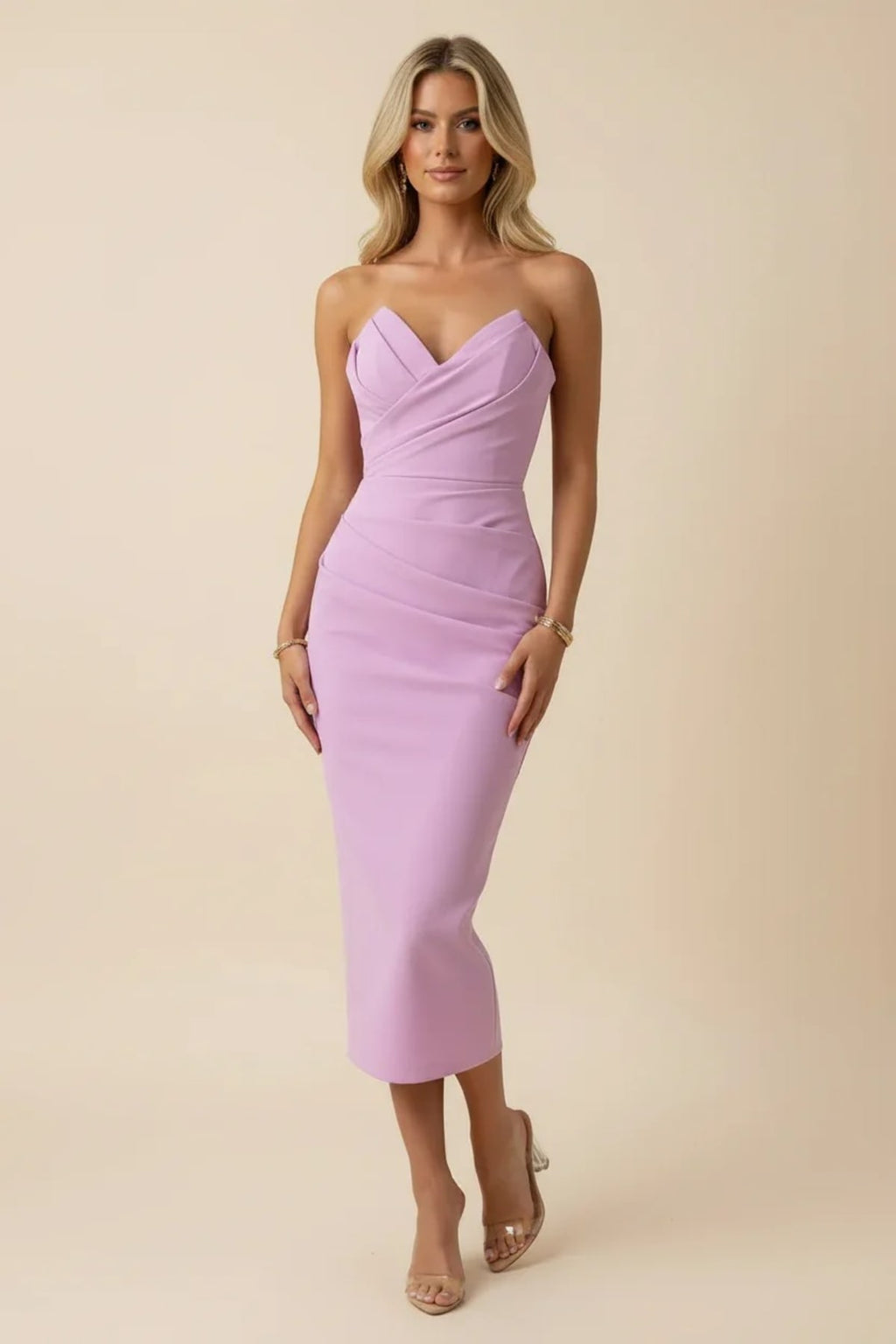 Blonde woman in a strapless midi dress with ruched detailing.