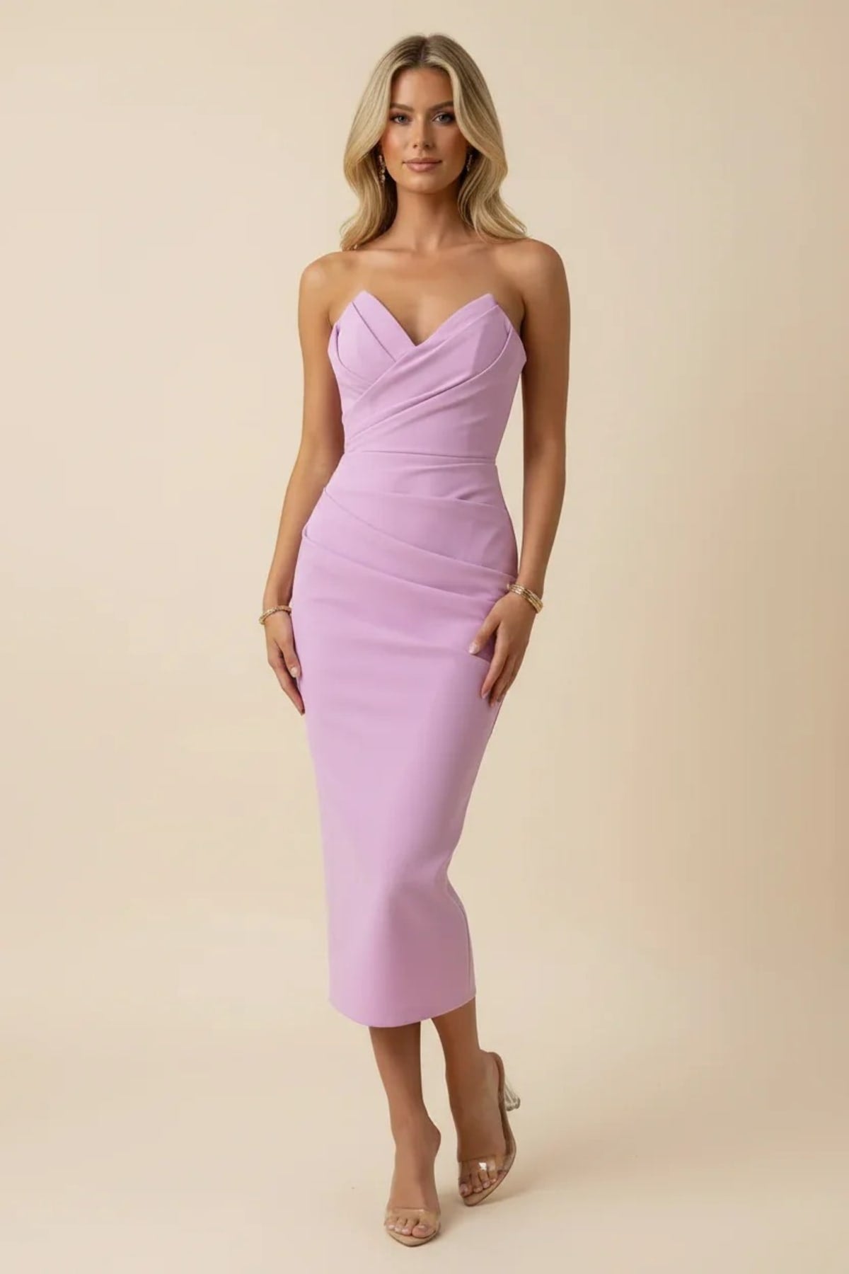 Blonde woman in a strapless midi dress with ruched detailing.
