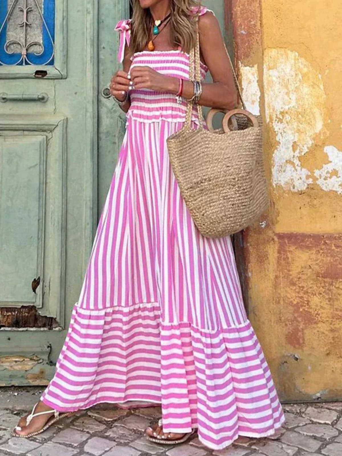 Striped summer dress with ruffle hem and tailored bodice.