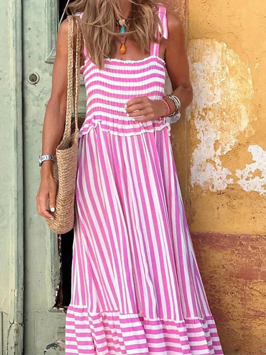 Striped summer dress with ruffle hem and tailored bodice.