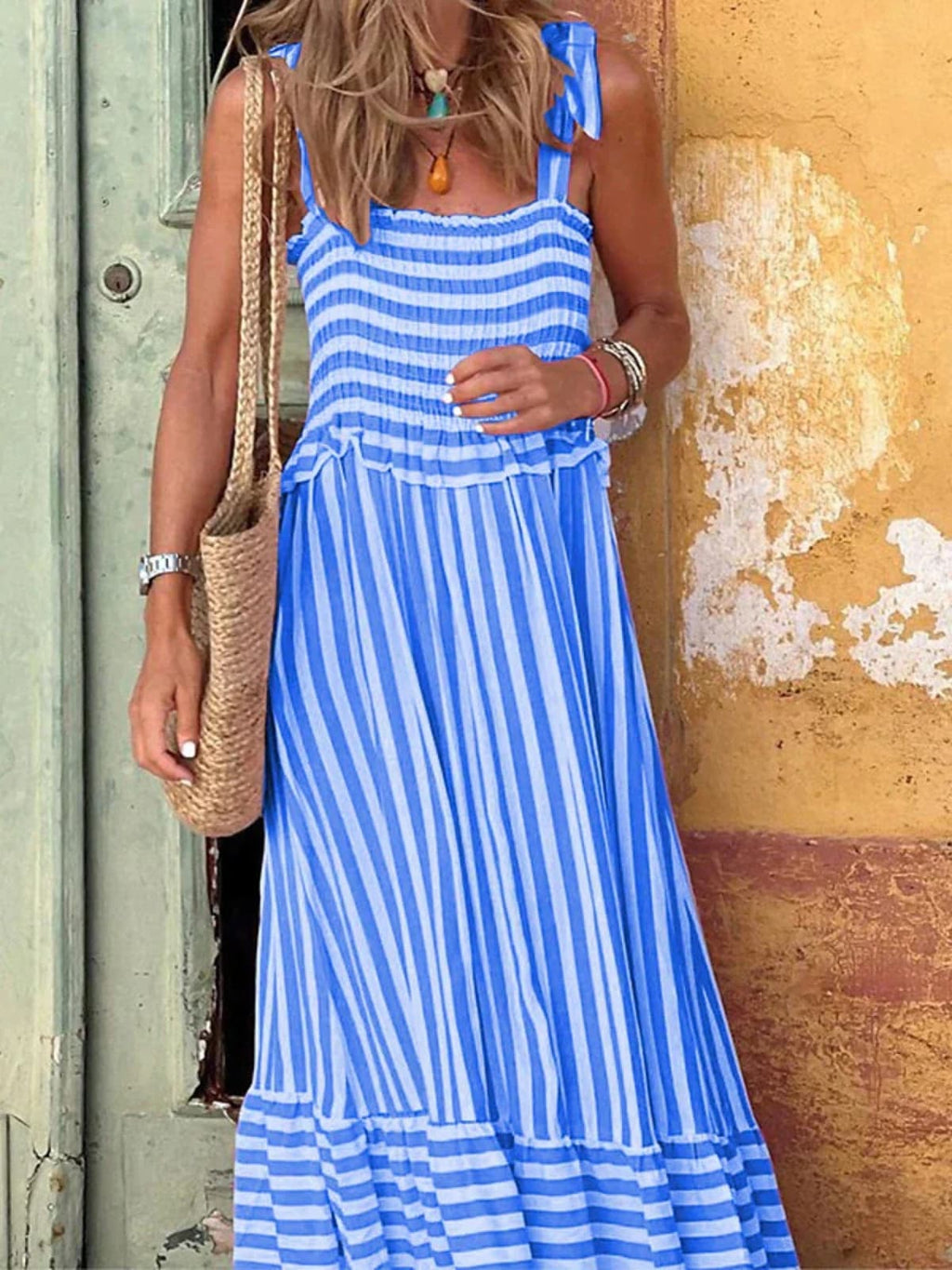 Striped summer dress with ruffle hem and tailored bodice.