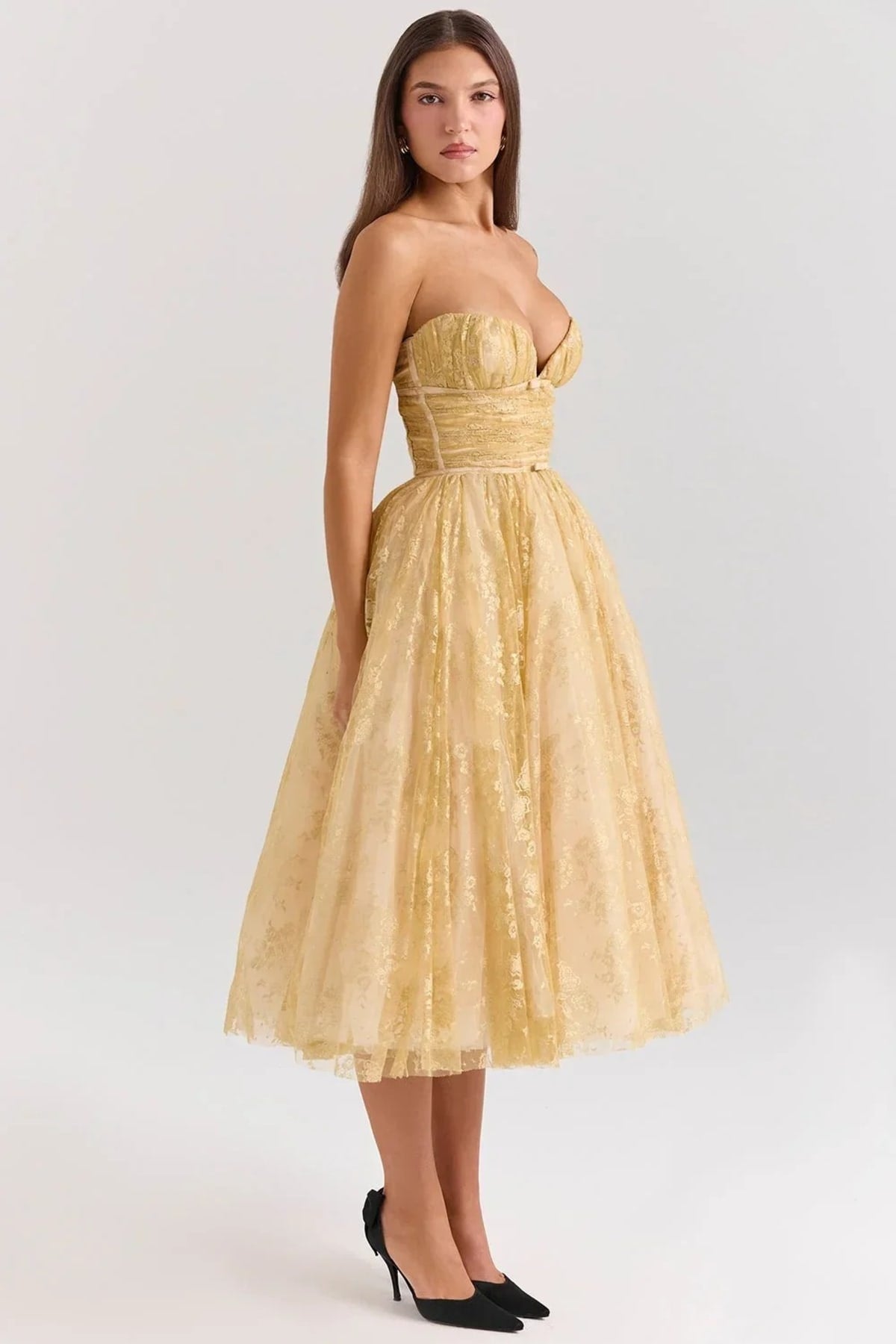 Woman in strapless midi dress with sweetheart neckline, full skirt.