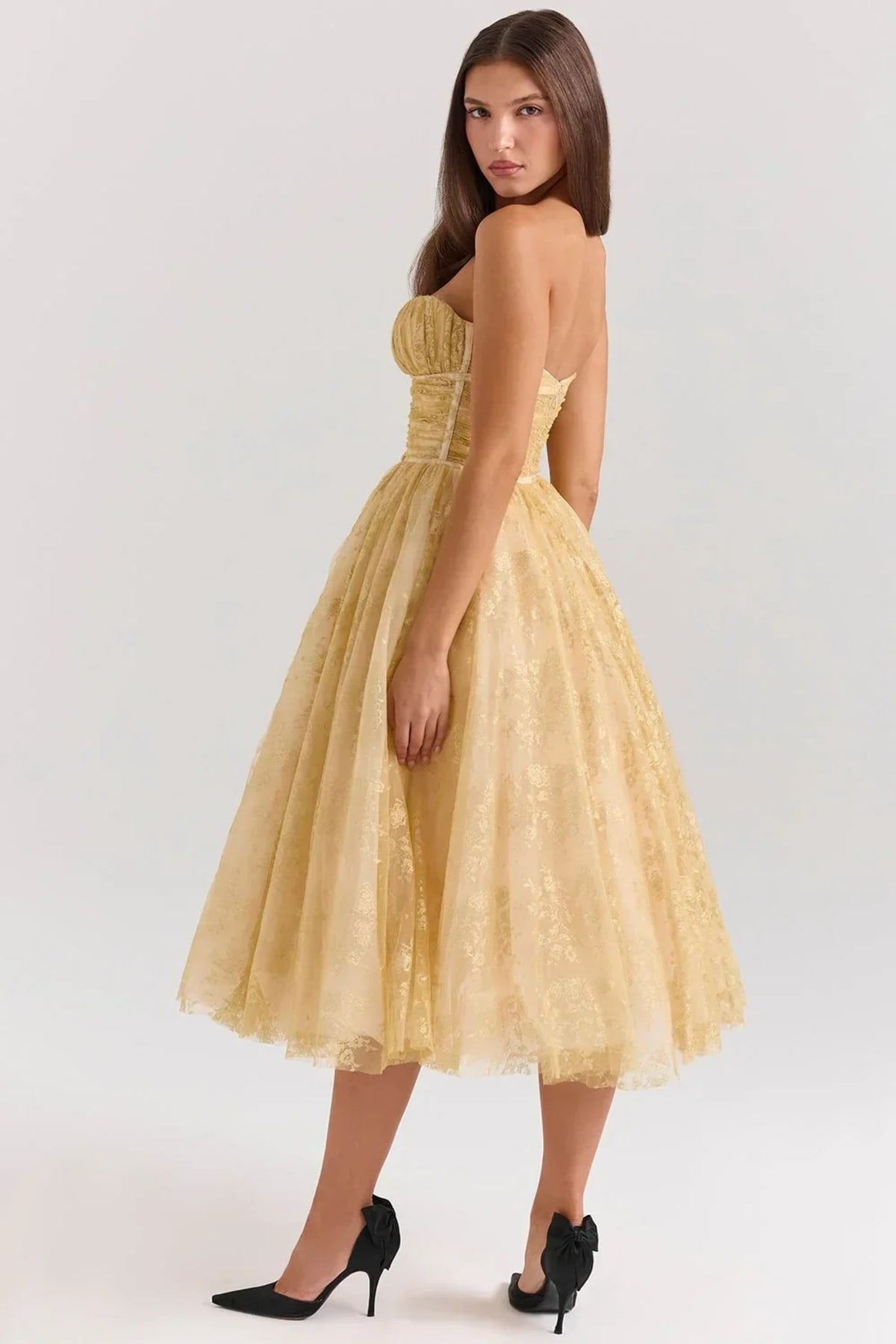 Woman in strapless midi dress with sweetheart neckline, full skirt.