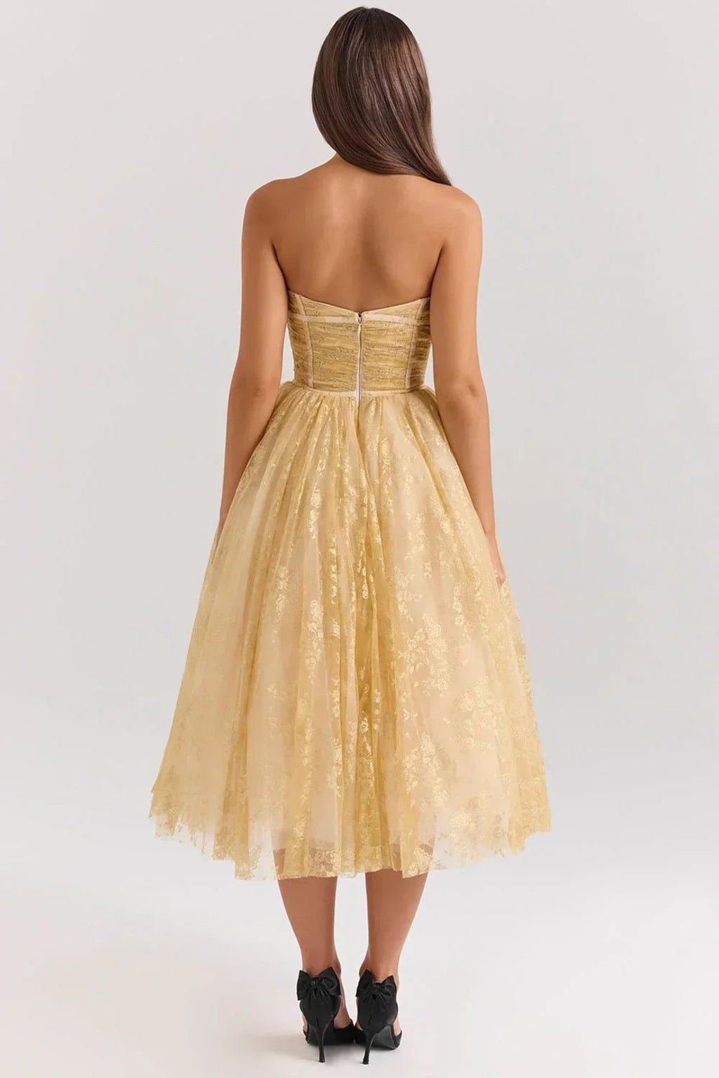 Woman in strapless midi dress with sweetheart neckline, full skirt.