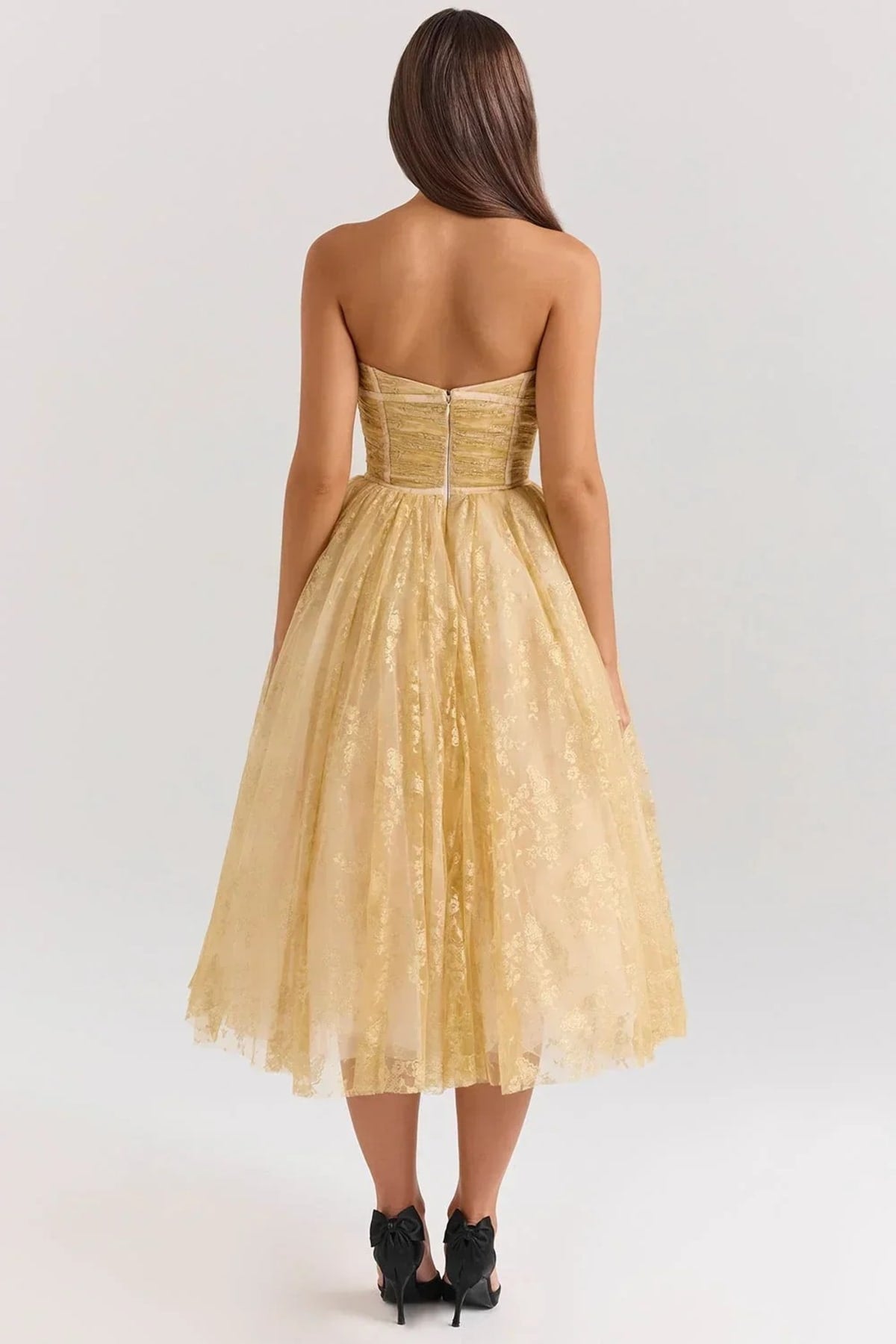 Woman in strapless midi dress with sweetheart neckline, full skirt.