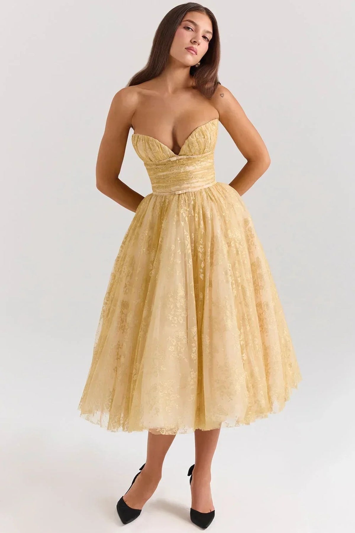 Woman in strapless midi dress with sweetheart neckline, full skirt.