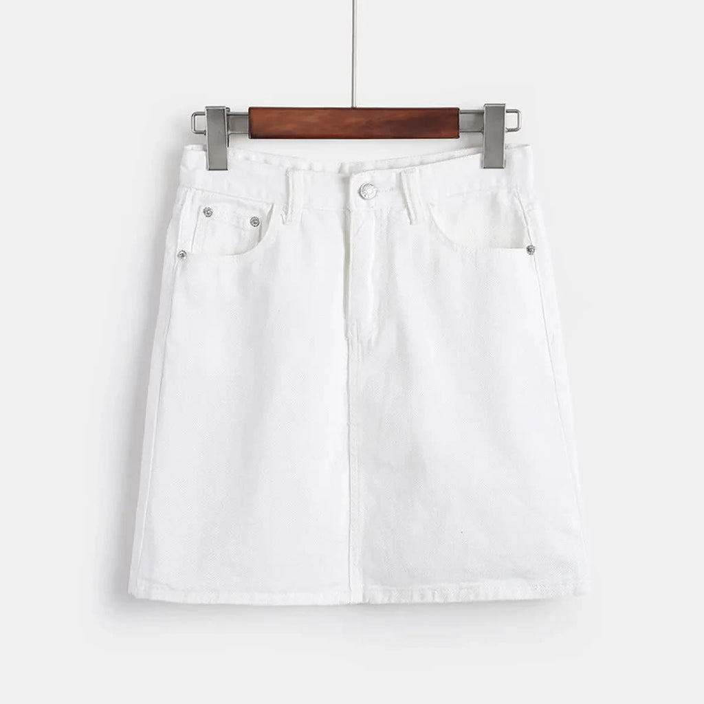 White denim mini skirt with A-line silhouette on hanger.