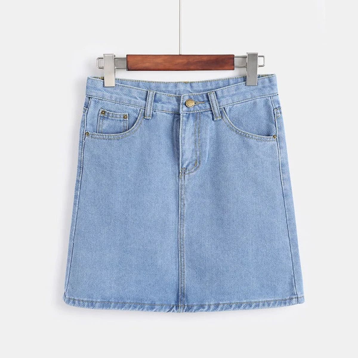 White denim mini skirt with A-line silhouette on hanger.