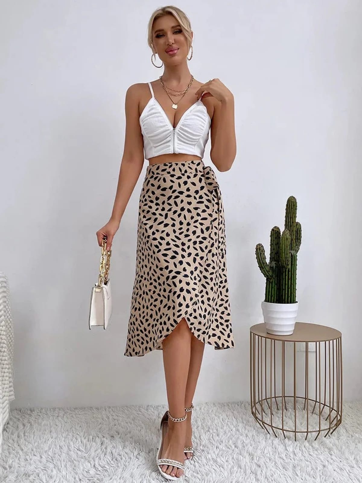 Woman in a wrap midi skirt with asymmetrical hem and tie-waist.