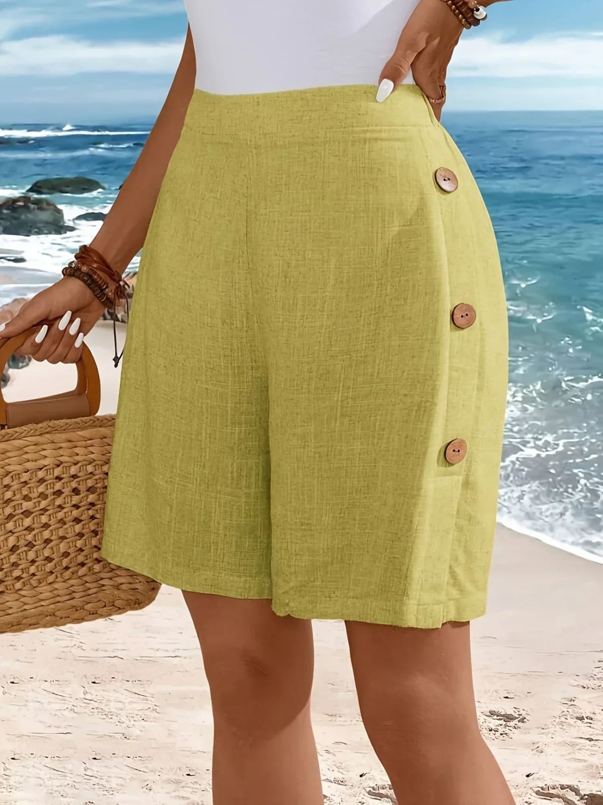 Mid-thigh shorts with side buttons and elastic waist.