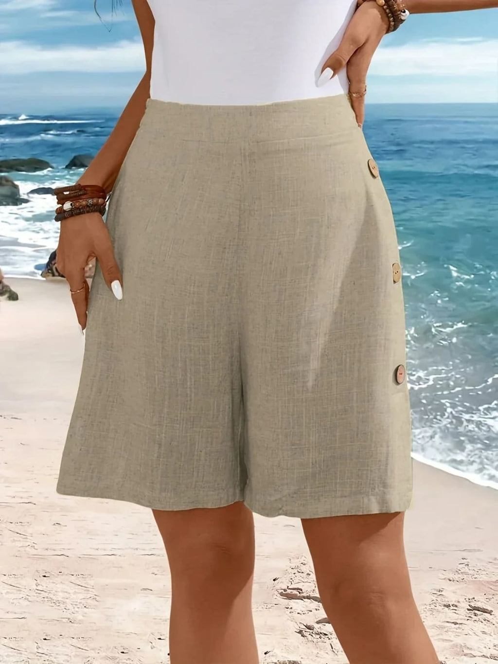 Mid-thigh shorts with side buttons and elastic waist.