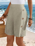 Mid-thigh shorts with side buttons and elastic waist.