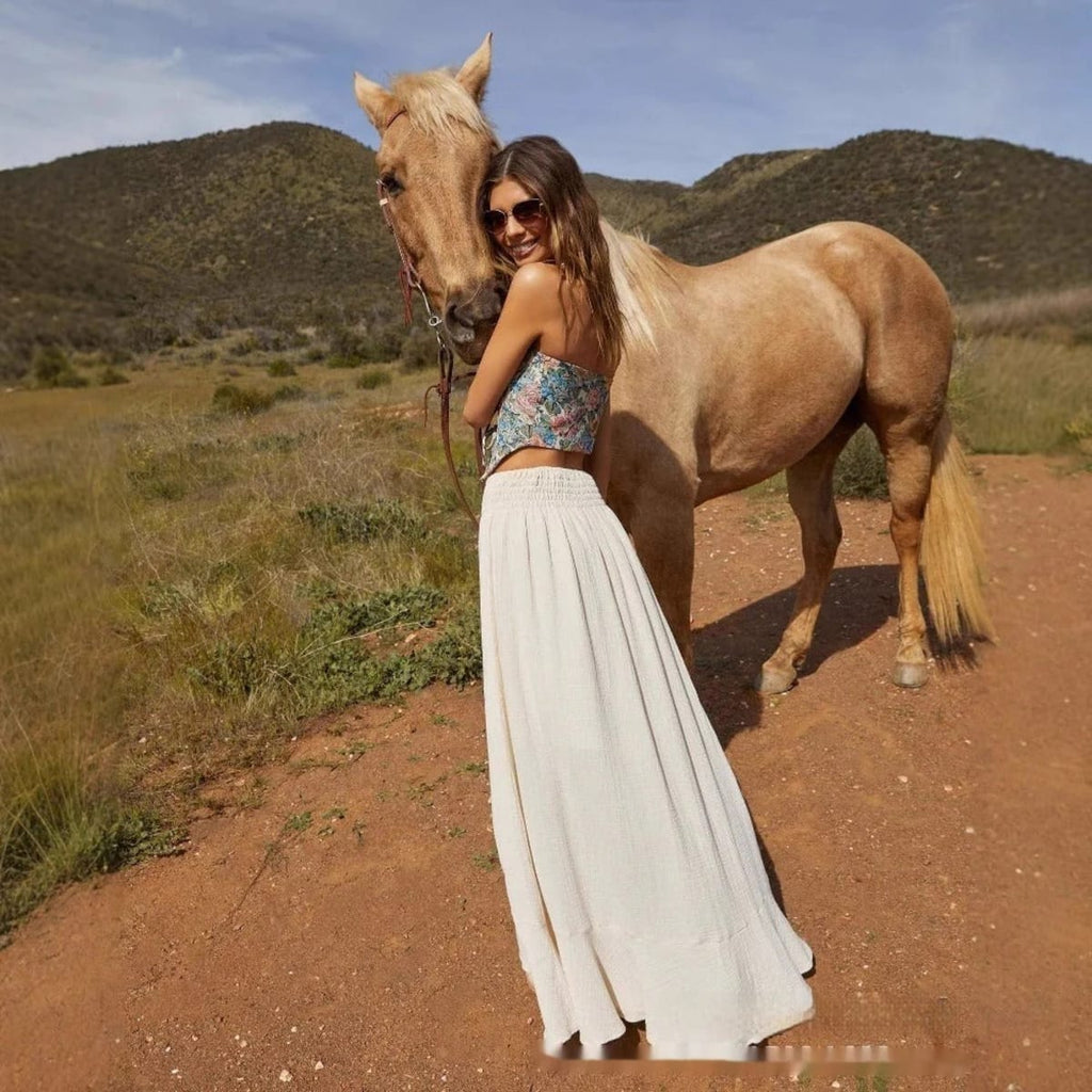 Woman wearing high-waisted button-front maxi skirt with drawstring waist.