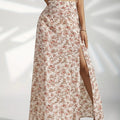 Woman wearing a floral maxi skirt with a side slit.