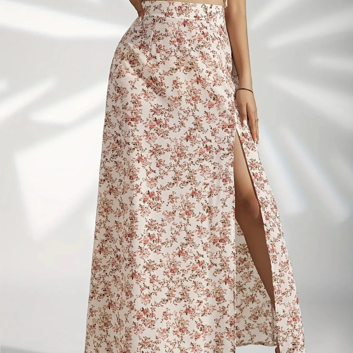 Woman wearing a floral maxi skirt with a side slit.