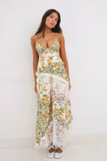 Woman wearing a floral and lace patchwork maxi dress with ruffles.