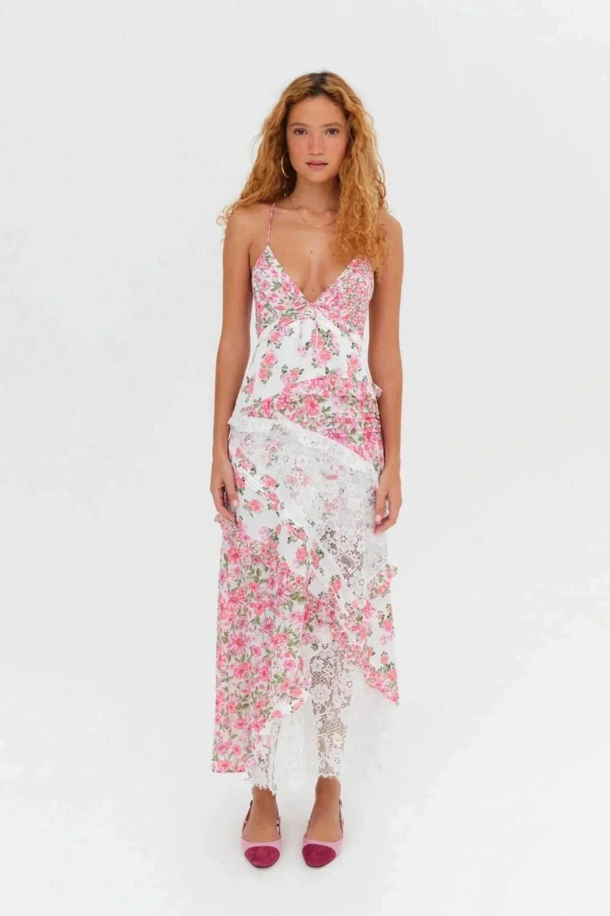 Woman wearing a floral and lace patchwork maxi dress with ruffles.