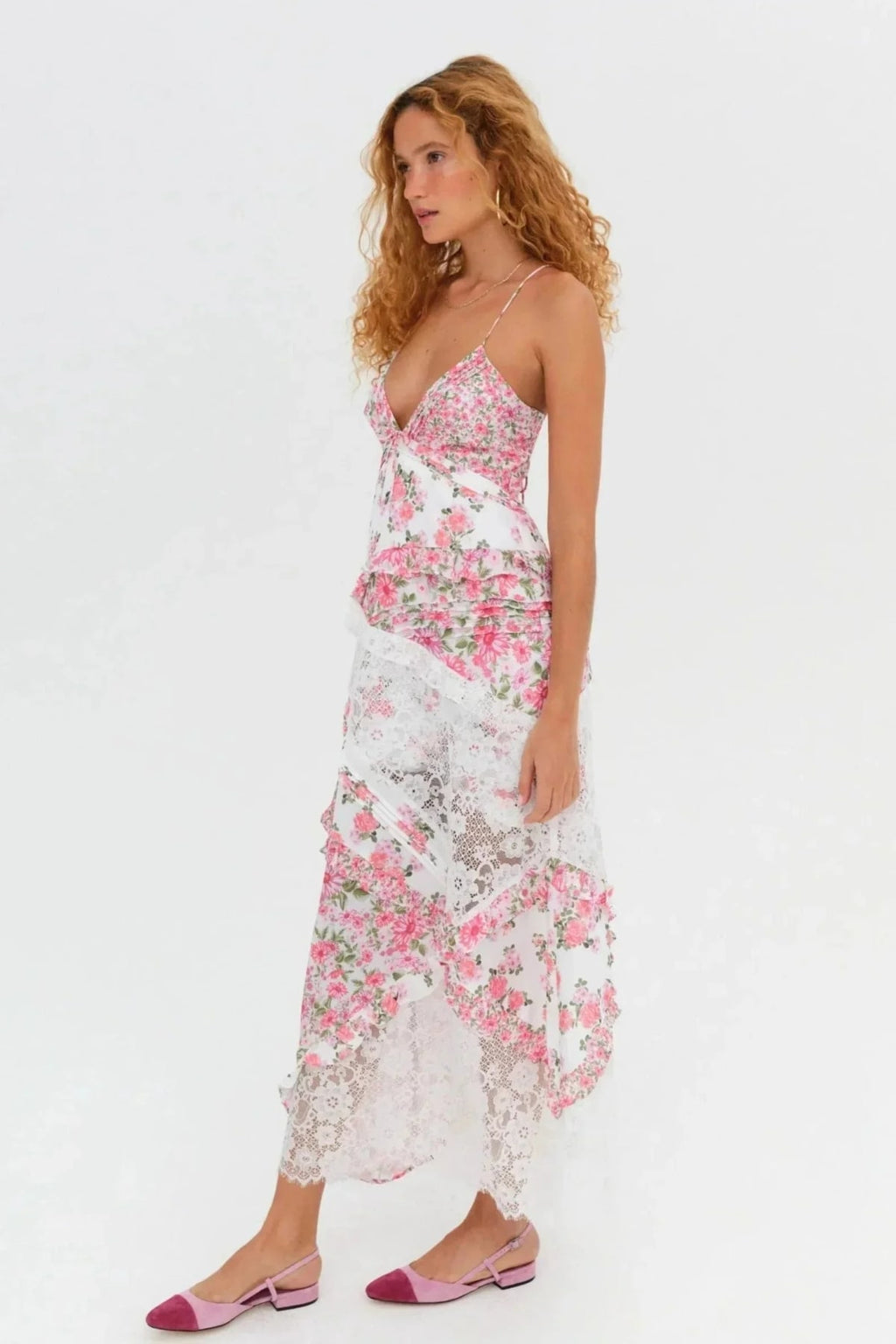 Woman wearing a floral and lace patchwork maxi dress with ruffles.