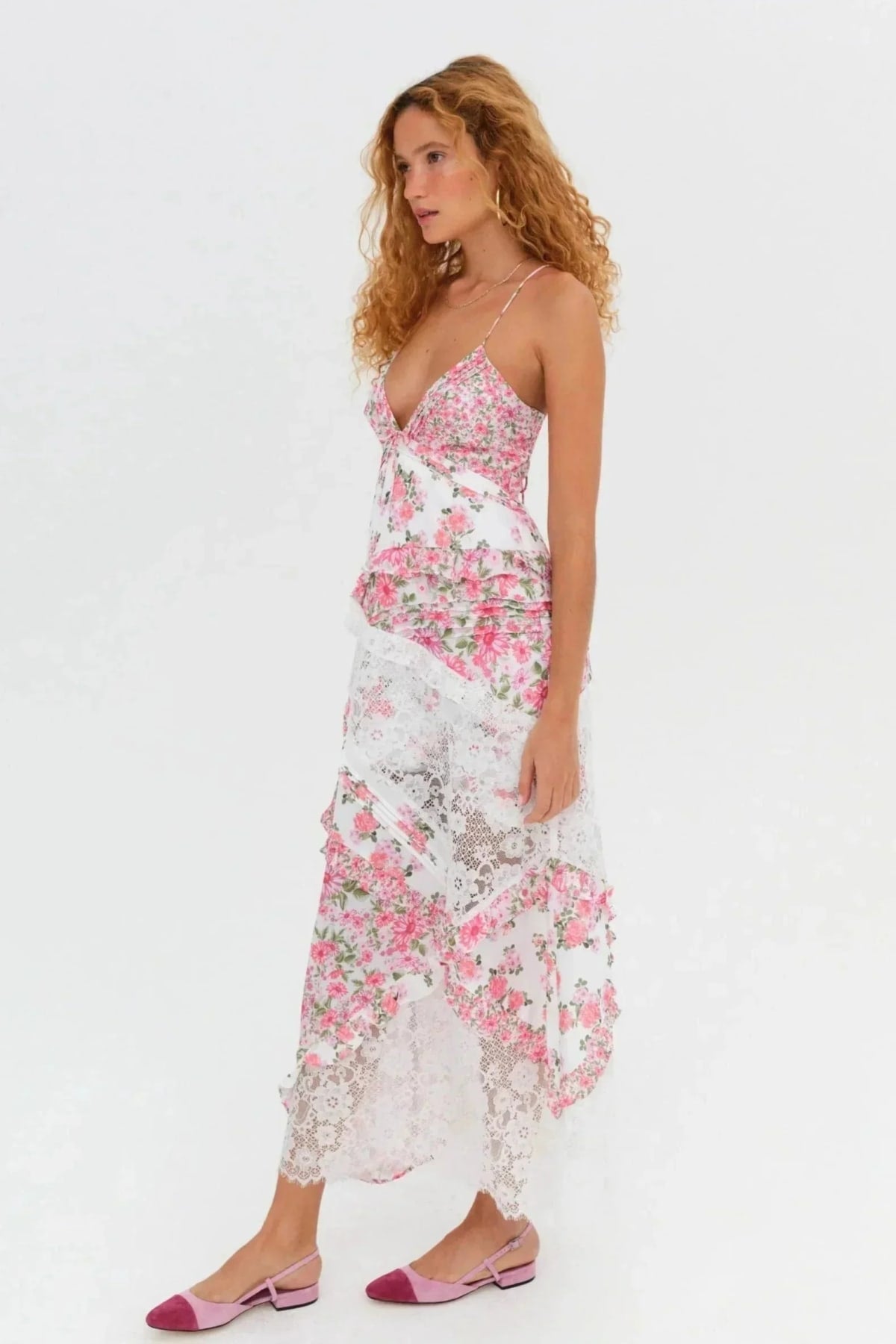 Woman wearing a floral and lace patchwork maxi dress with ruffles.