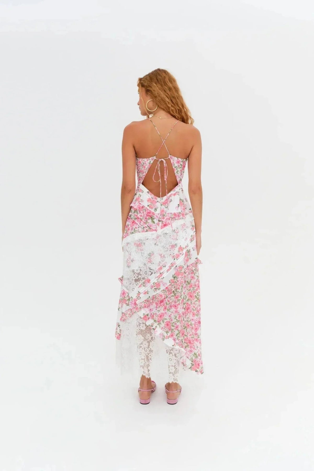 Woman wearing a floral and lace patchwork maxi dress with ruffles.