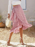 Woman wearing a floral wrap midi skirt with ruffles.