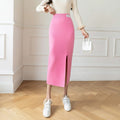 Model wearing a high-waisted knit midi pencil skirt with front slit.