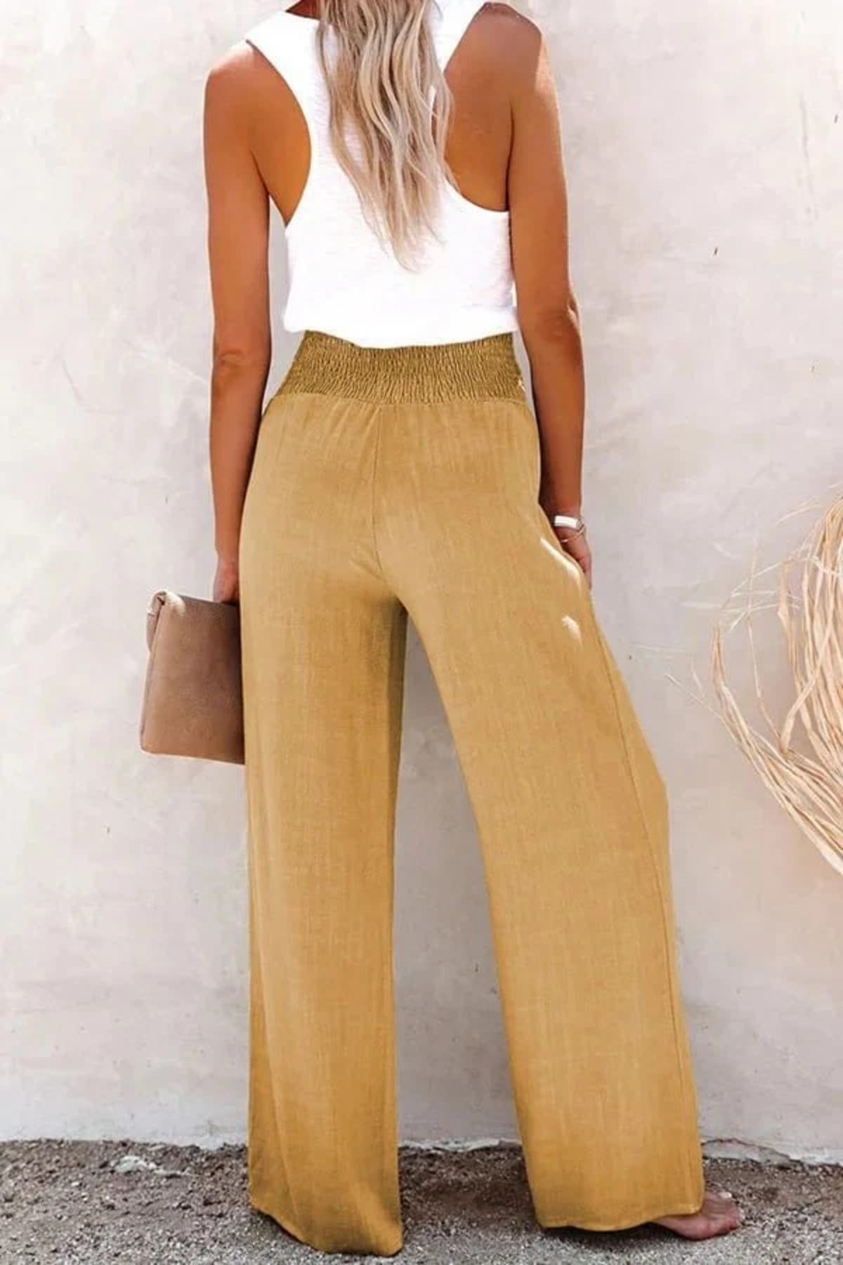 High-waisted trousers with smocked waistband and button details.