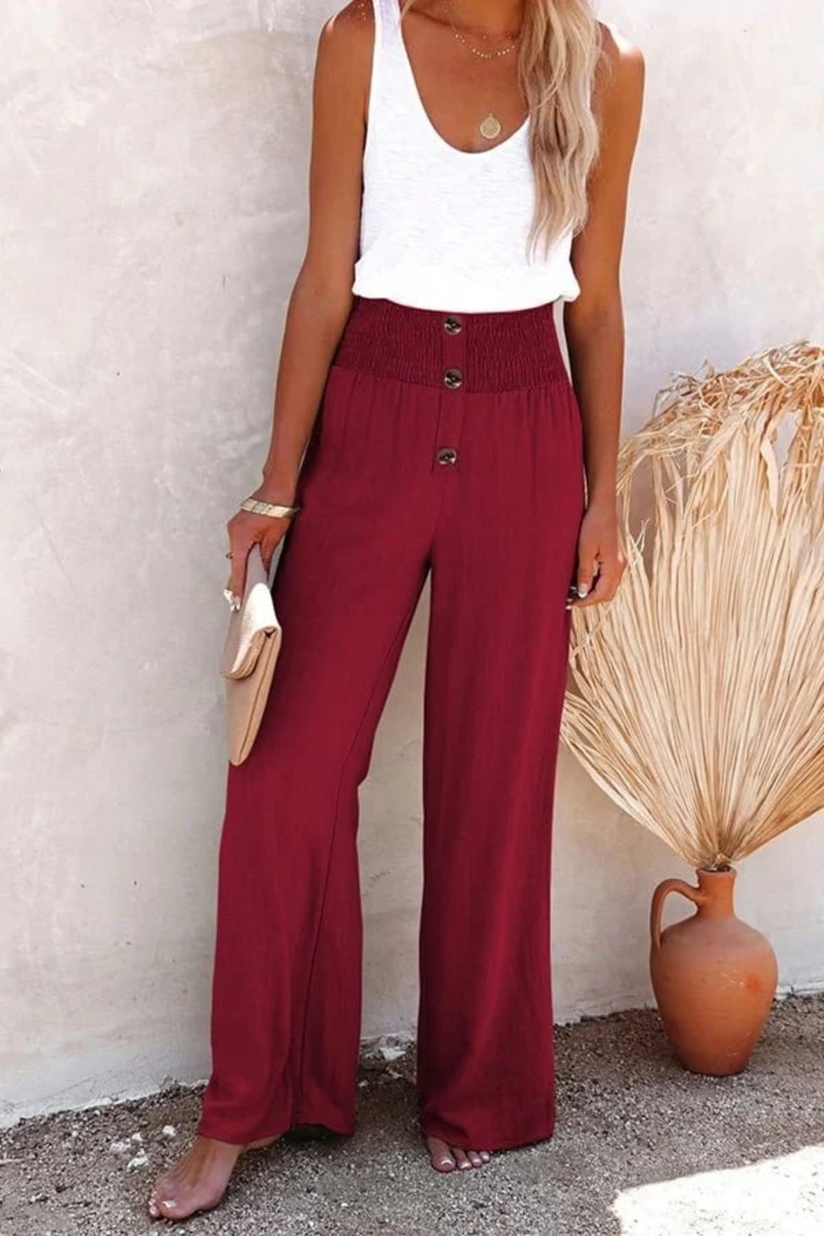 High-waisted trousers with smocked waistband and button details.