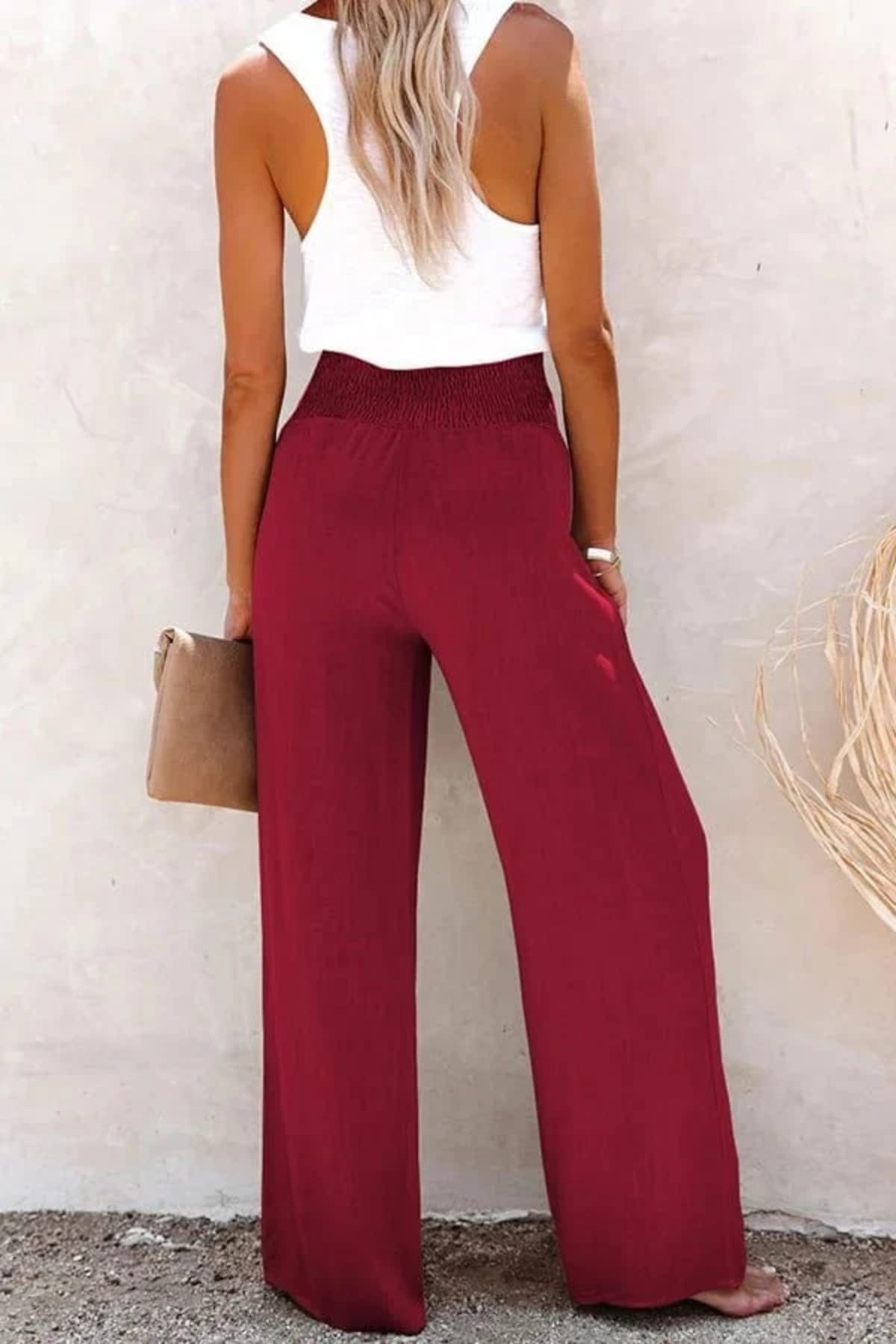 High-waisted trousers with smocked waistband and button details.