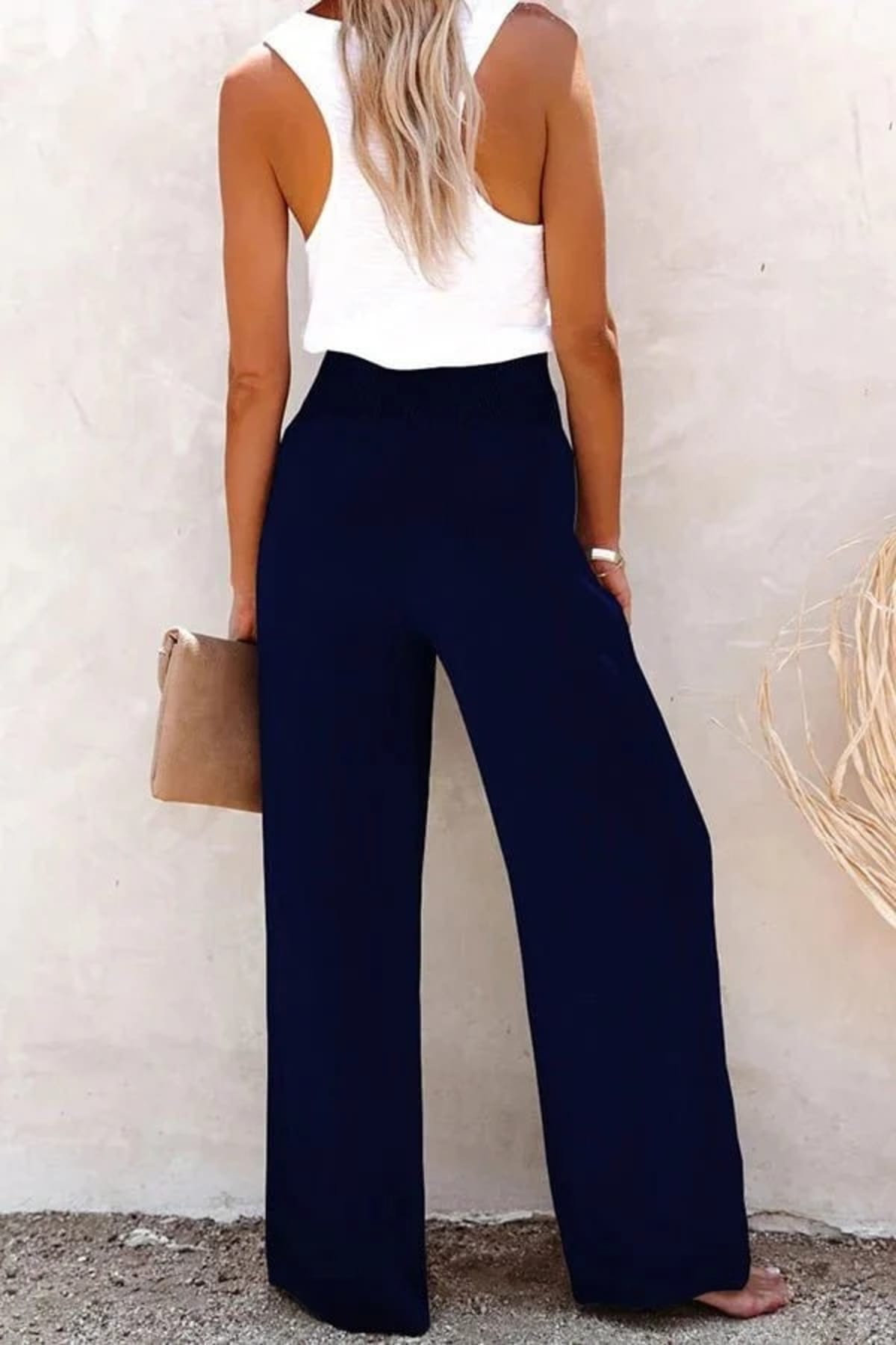 High-waisted trousers with smocked waistband and button details.