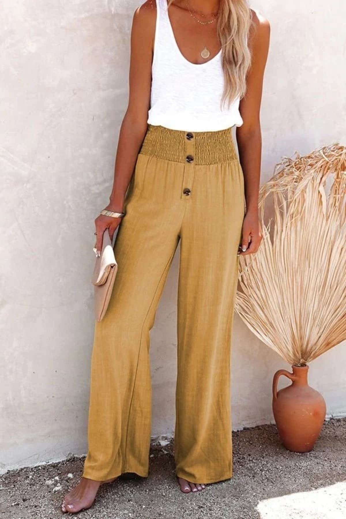 High-waisted trousers with smocked waistband and button details.