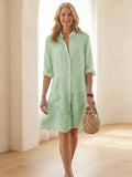Women's striped tiered dress with button front and 3/4 sleeves.