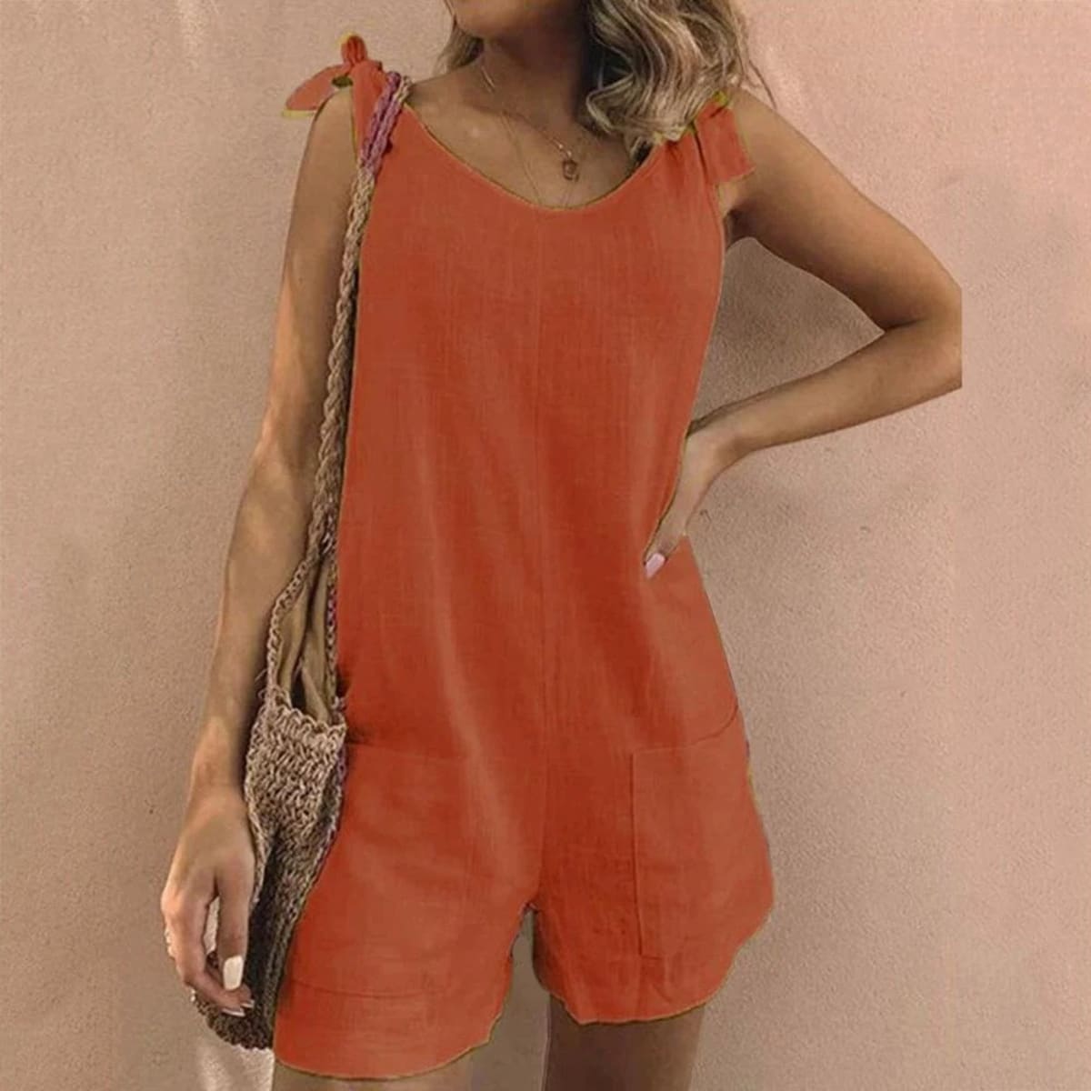 Relaxed fit playsuit with bow straps and pockets.